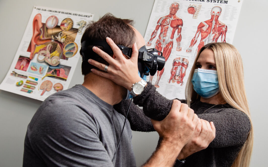 Dix-hallpike test for BPPV. A Physiotherapist holds a clients head to the side while they wear VNG goggles so she can treat his vertigo caused by BPPV.